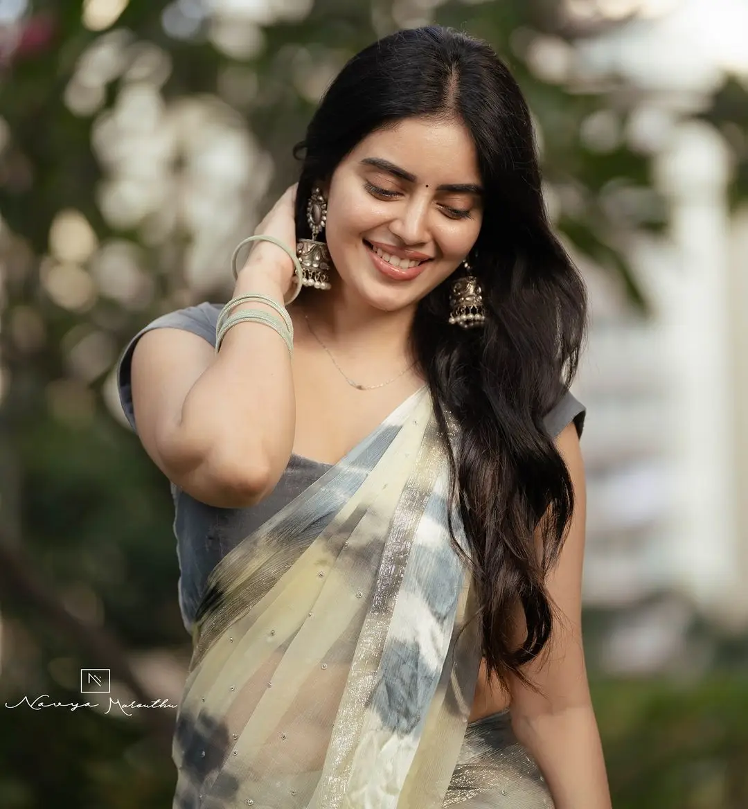 Navya Marouthu Wearing White Saree Sleeveless Black Blouse